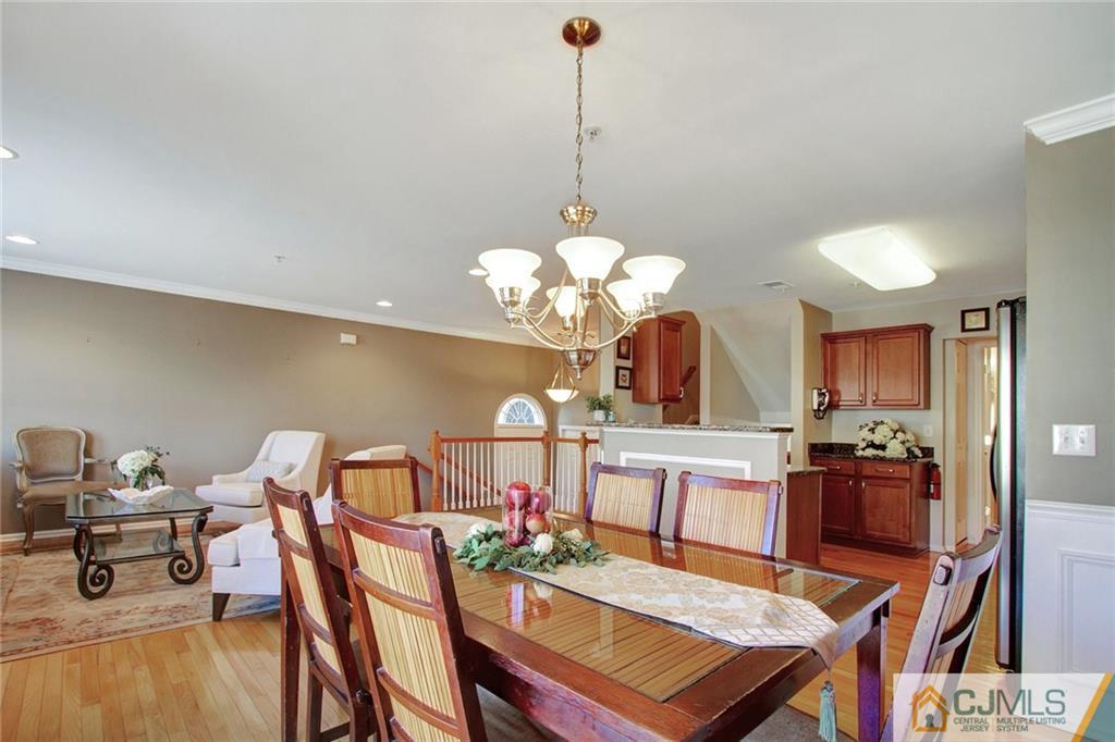 21 Raritan Reach Road, Unit 11 South Amboy, NJ 08879 - Photo 10 of 28 a view of a dining room with furniture and chandelier