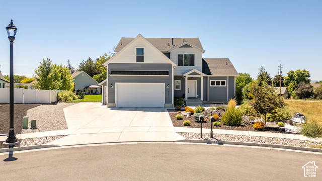 447 Wasatch Boulevard Smithfield, UT 84335 - Photo 1 of 1 View of front of house with concrete driveway, a garage, and a shingled roof