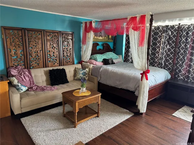 a living room with furniture and a painting on the wall