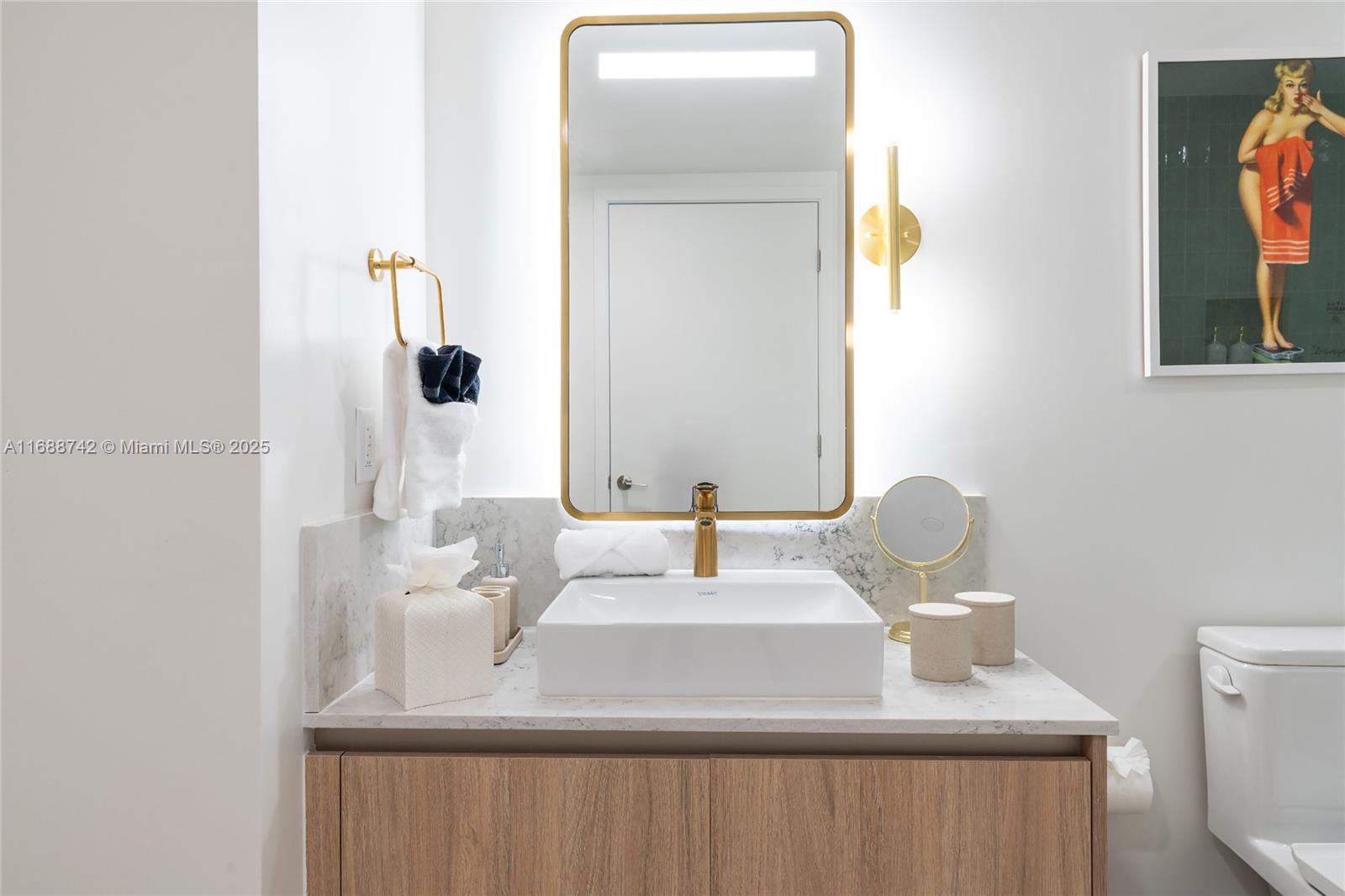 159 Northeast 6th Street, Unit 3013 Miami, FL 33132 - Photo 19 of 53 a bathroom with a sink and a mirror