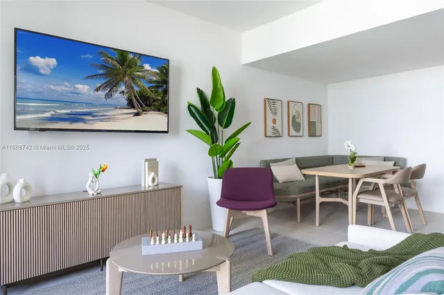 a dining room with furniture a rug and a painting