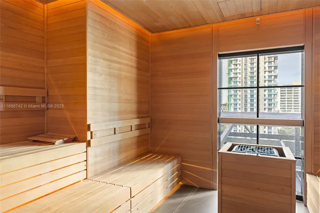 a spacious bathroom with a sink a toilet a mirror and shower