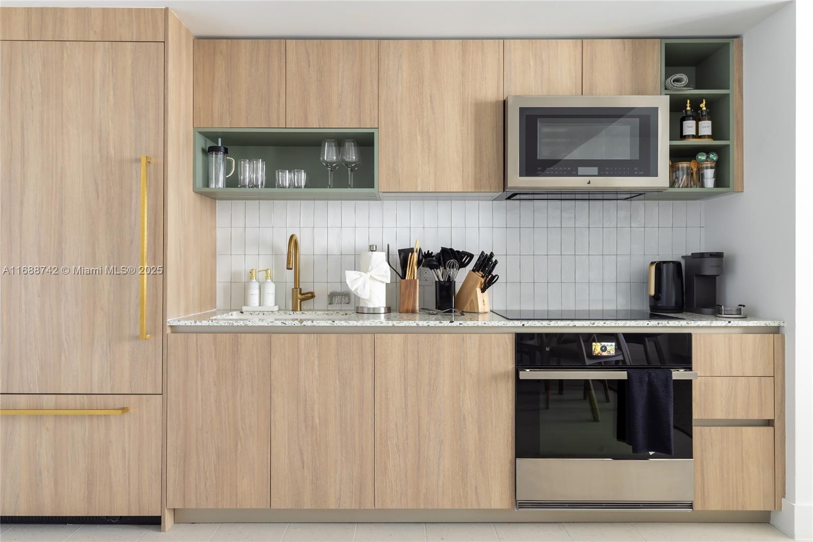 159 Northeast 6th Street, Unit 3013 Miami, FL 33132 - Photo 7 of 53 a kitchen with stainless steel appliances granite countertop white cabinets and a stove top oven