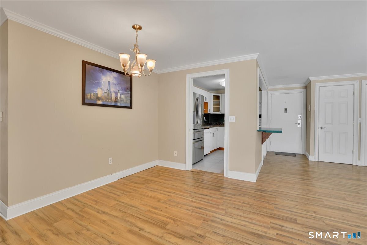 565 Talcottville Road, Unit 1A1 Vernon, CT 06066 - Photo 13 of 27 a view of empty room with wooden floor