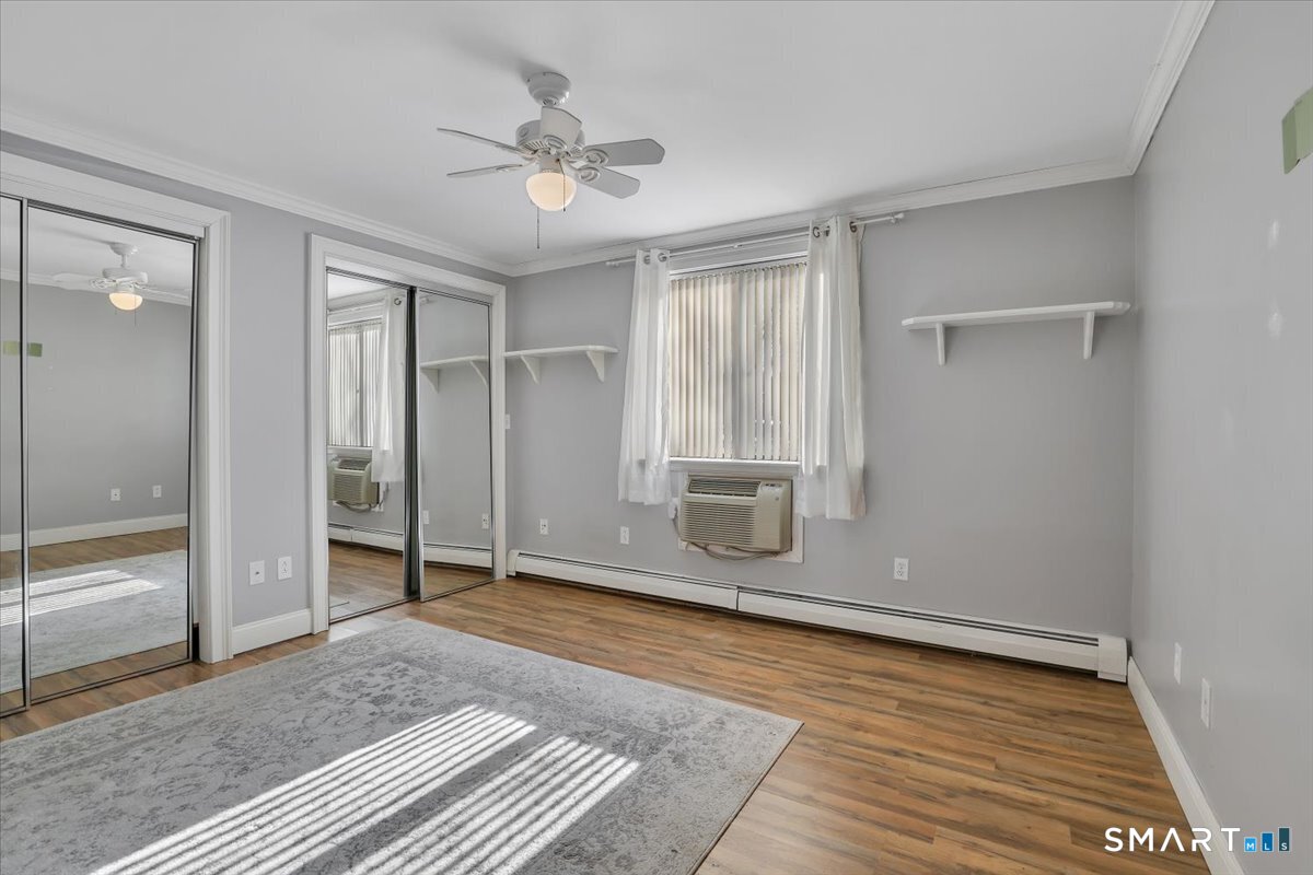 565 Talcottville Road, Unit 1A1 Vernon, CT 06066 - Photo 16 of 27 wooden floor in an empty room with a window