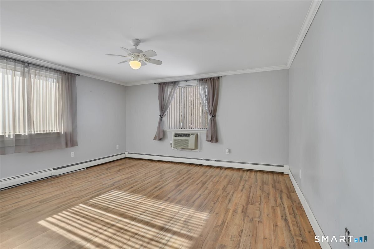 565 Talcottville Road, Unit 1A1 Vernon, CT 06066 - Photo 19 of 27 wooden floor in an empty room with a window