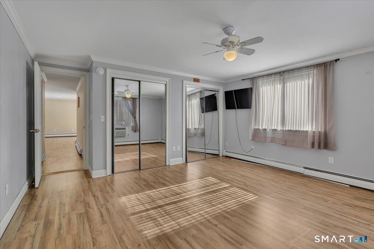 565 Talcottville Road, Unit 1A1 Vernon, CT 06066 - Photo 20 of 27 a view of an empty room with wooden floor and a window