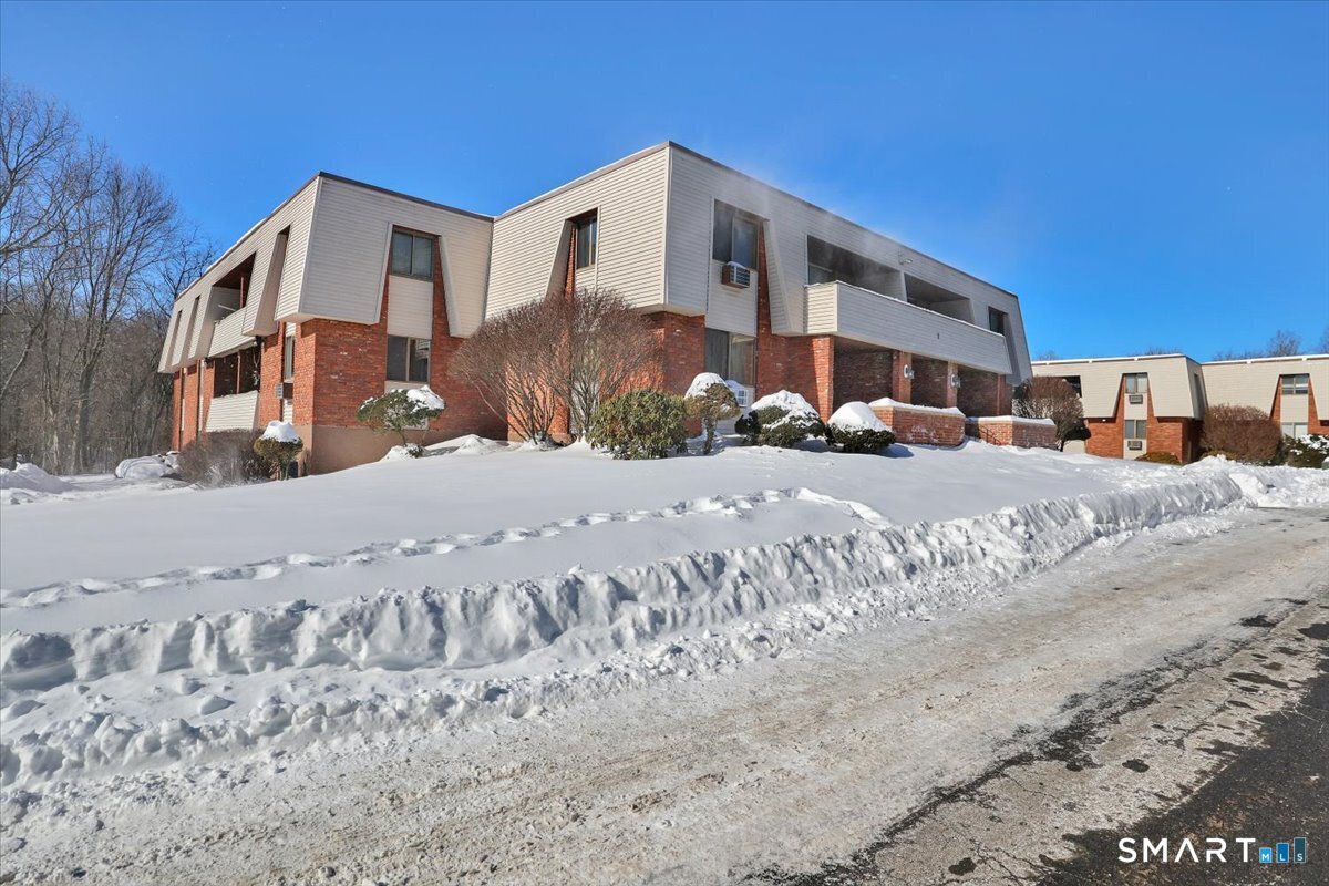 565 Talcottville Road, Unit 1A1 Vernon, CT 06066 - Photo 27 of 27 a front view of a building with a road