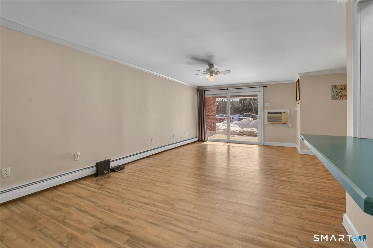 565 Talcottville Road, Unit 1A1 Vernon, CT 06066 - Photo 6 of 27 a view of empty room with wooden floor and fan