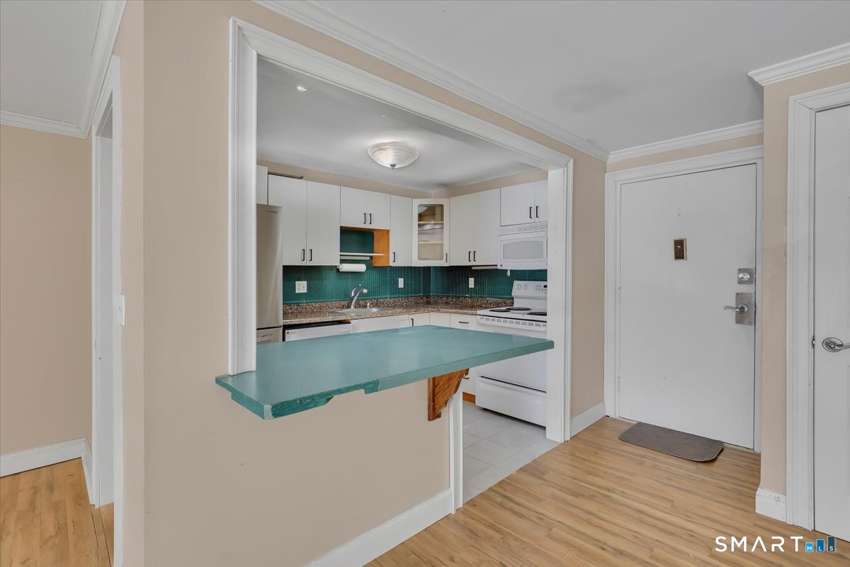 565 Talcottville Road, Unit 1A1 Vernon, CT 06066 - Photo 8 of 27 a kitchen with stainless steel appliances granite countertop a refrigerator and a stove