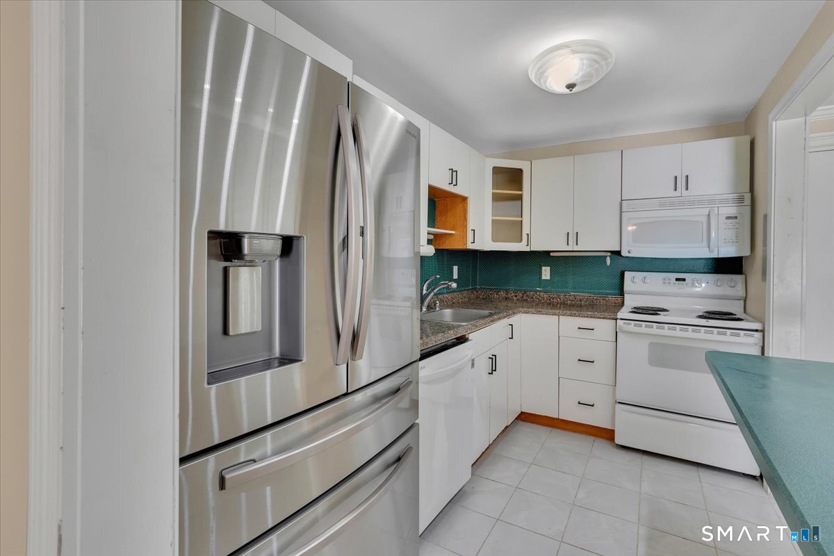 565 Talcottville Road, Unit 1A1 Vernon, CT 06066 - Photo 9 of 27 a kitchen with stainless steel appliances a refrigerator sink and cabinets