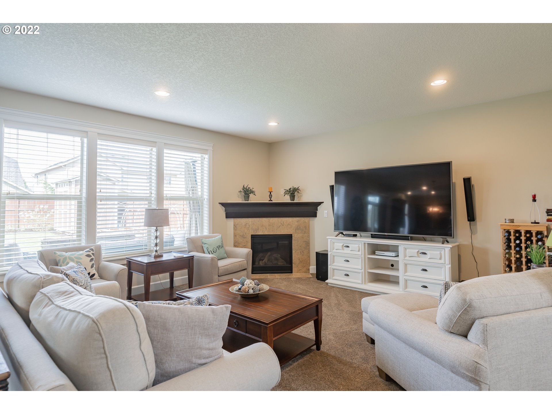 133 North 39th Court Ridgefield, WA 98642 - Photo 5 of 30 a living room with furniture a flat screen tv and a fireplace