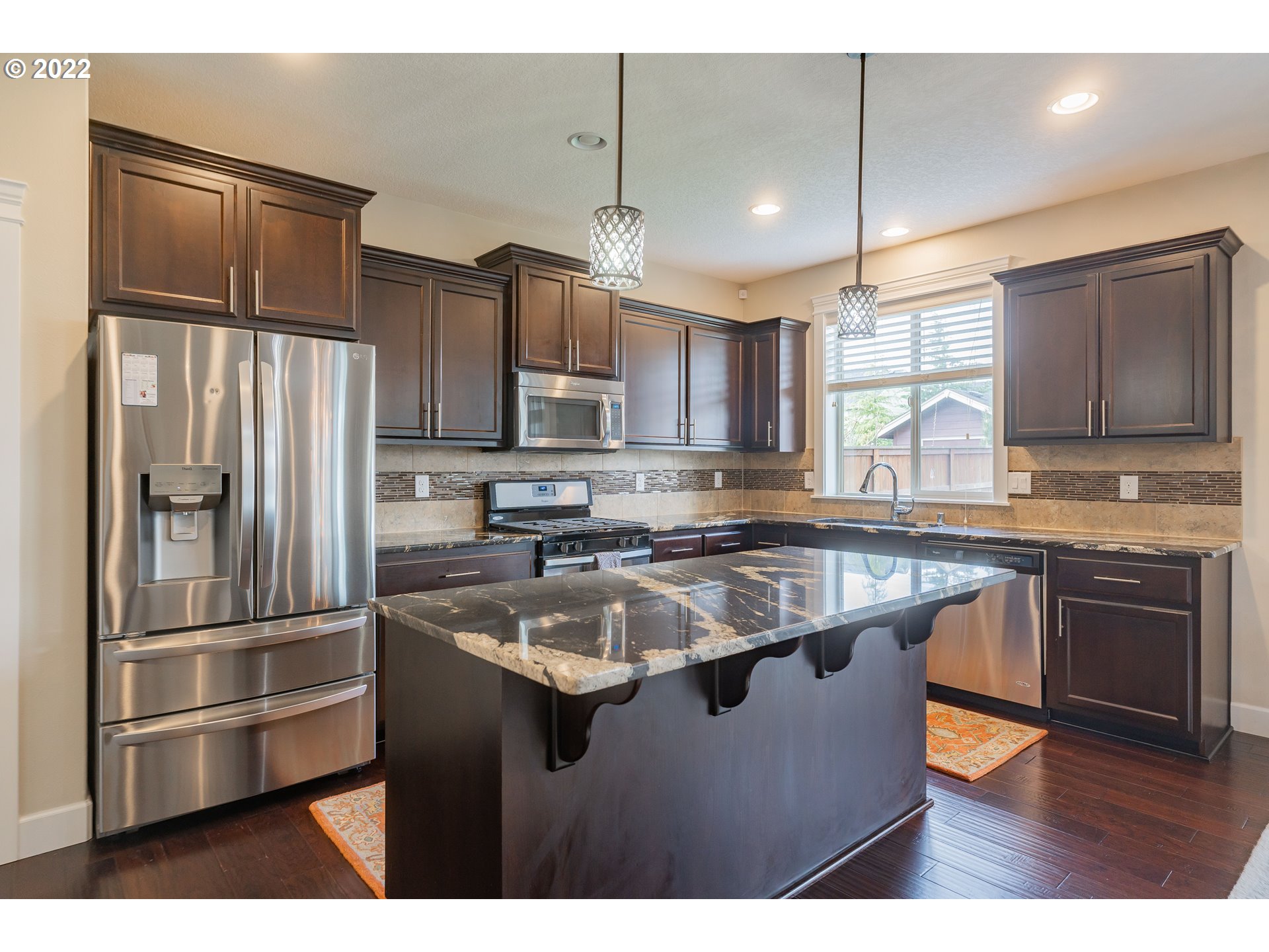 133 North 39th Court Ridgefield, WA 98642 - Photo 8 of 30 a kitchen with kitchen island a counter top space appliances and cabinets