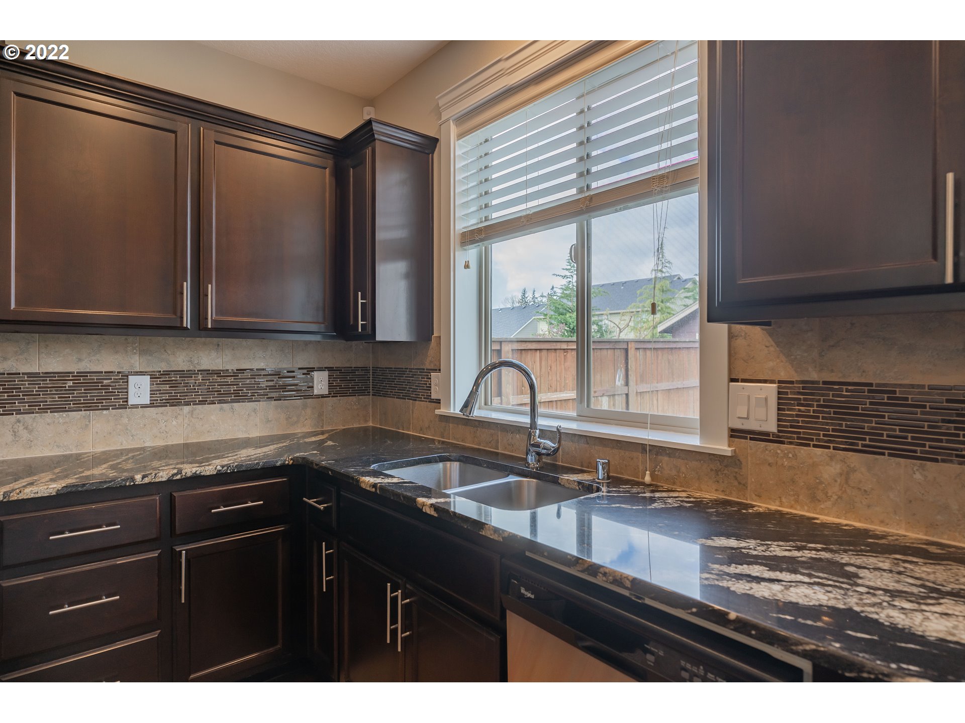 133 North 39th Court Ridgefield, WA 98642 - Photo 9 of 30 a kitchen with granite countertop a sink a stove and cabinets