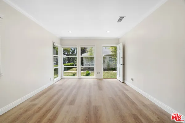 wooden floor in an empty room with a window