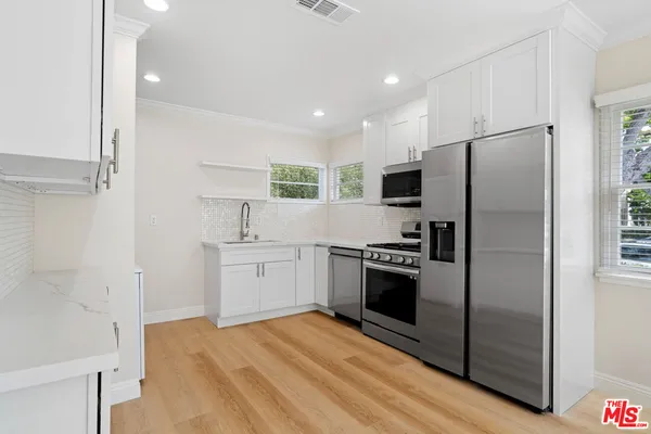 a kitchen with a refrigerator stove and sink