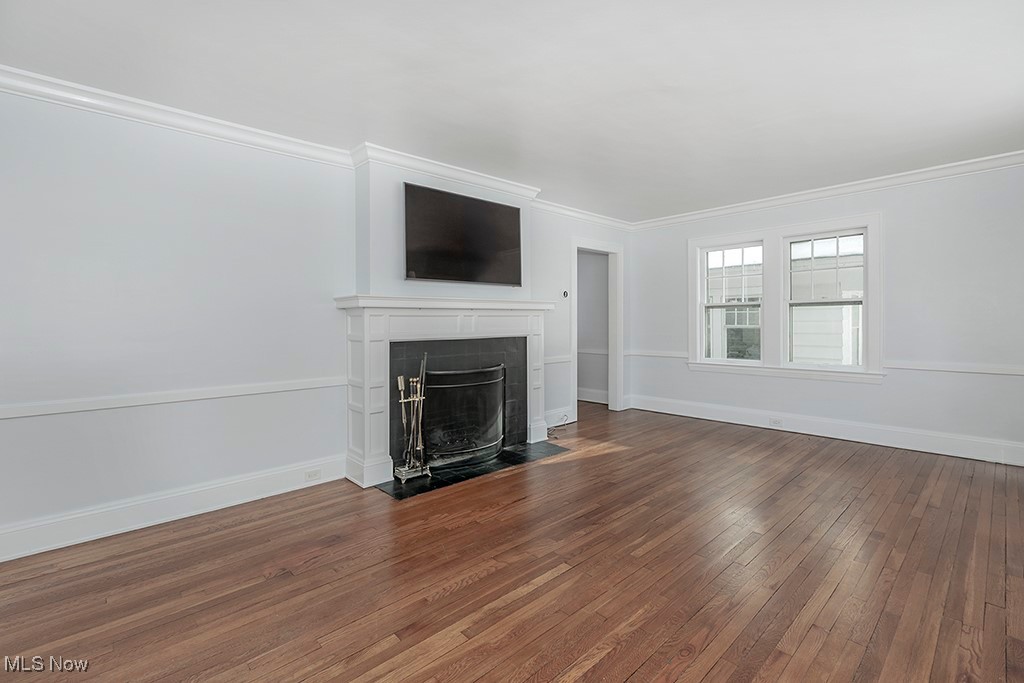 2596 Ashton Road Cleveland, OH 44118 - Photo 5 of 43 Unfurnished living room featuring dark hardwood / wood-style flooring and ornamental molding