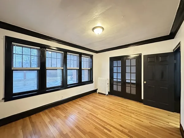 wooden floor in an empty room with a window
