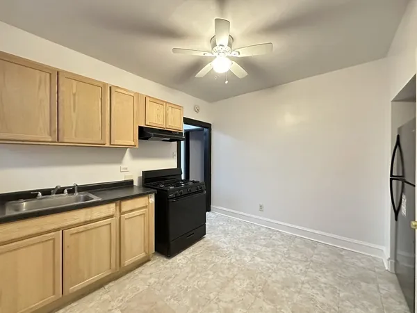 a kitchen with cabinets and appliances