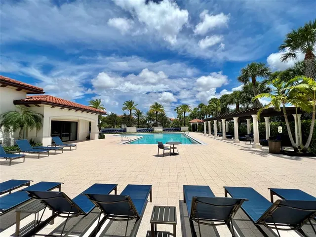 a view of a house with swimming pool and sitting area