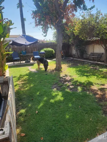 a swimming pool with outdoor seating yard and barbeque oven