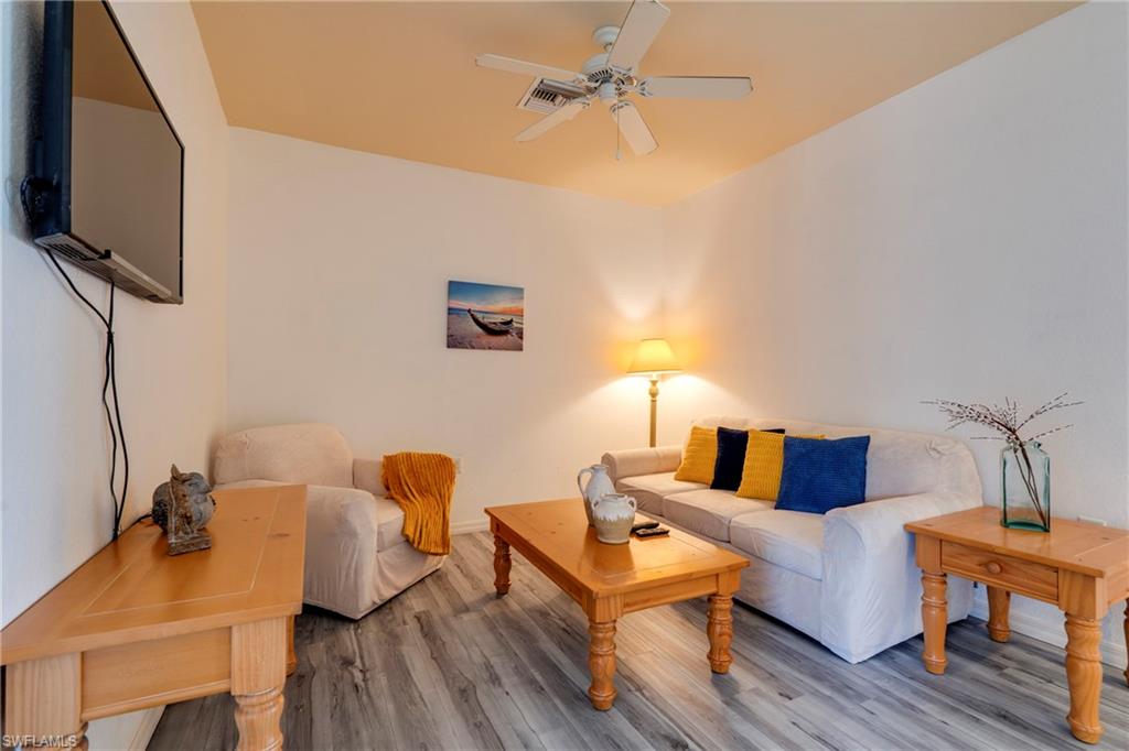 7930 Mahogany Run Lane, Unit 824 Naples, FL 34113 - Photo 15 of 40 a living room with furniture and a flat screen tv