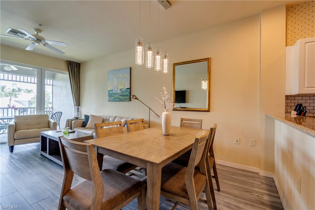 7930 Mahogany Run Lane, Unit 824 Naples, FL 34113 - Photo 16 of 40 a view of a dining room with furniture window and wooden floor