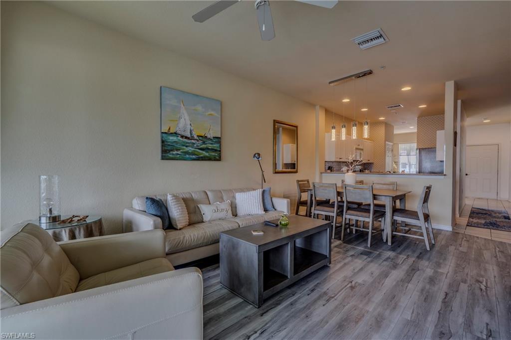 7930 Mahogany Run Lane, Unit 824 Naples, FL 34113 - Photo 19 of 40 a living room with furniture kitchen view and a dining table