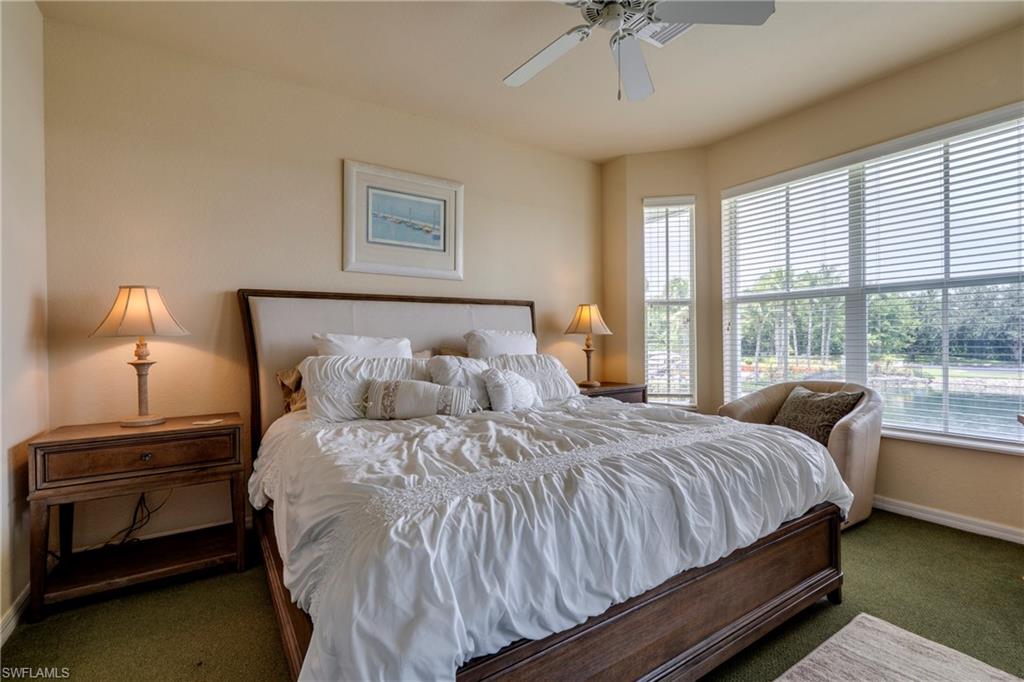 7930 Mahogany Run Lane, Unit 824 Naples, FL 34113 - Photo 20 of 40 a bedroom with a bed and a night stand