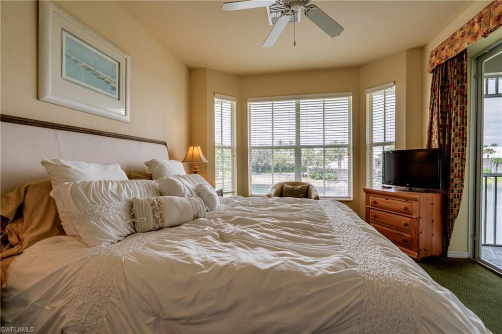 7930 Mahogany Run Lane, Unit 824 Naples, FL 34113 - Photo 21 of 40 a bedroom with furniture and a flat screen tv