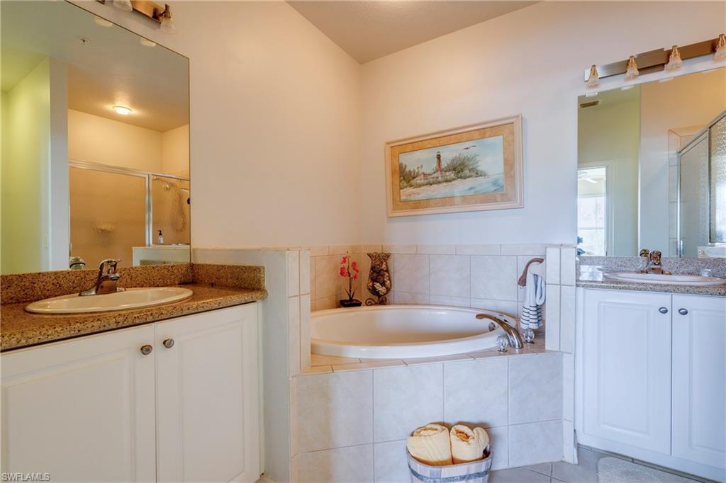 7930 Mahogany Run Lane, Unit 824 Naples, FL 34113 - Photo 23 of 40 a bathroom with a sink and a mirror