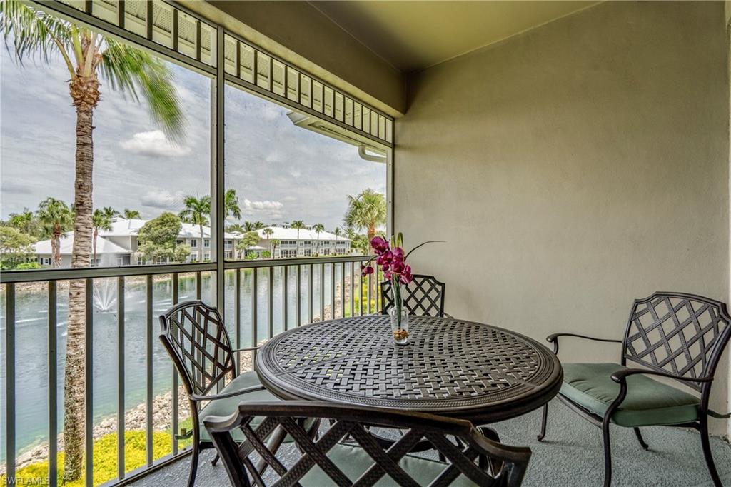 7930 Mahogany Run Lane, Unit 824 Naples, FL 34113 - Photo 28 of 40 a view of a balcony with table and chairs