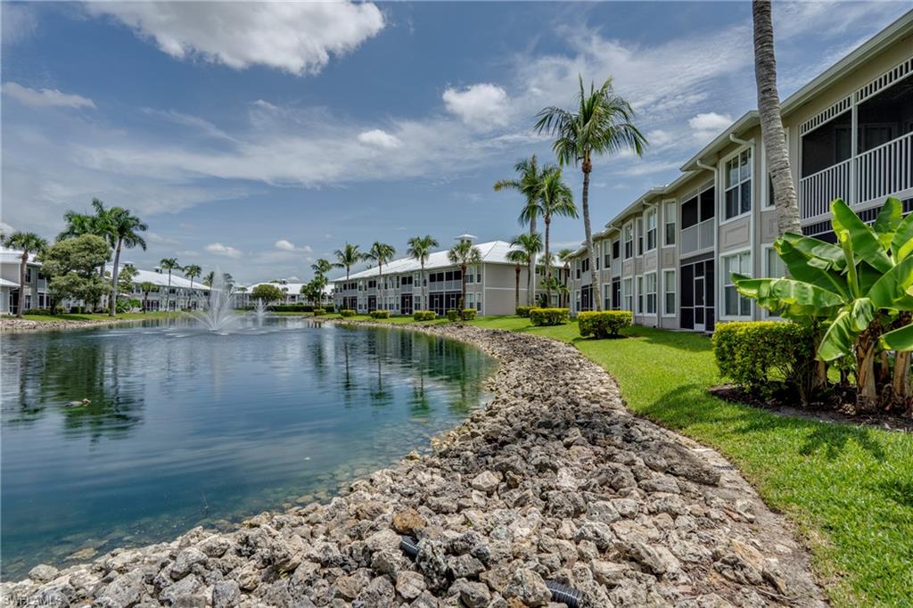 7930 Mahogany Run Lane, Unit 824 Naples, FL 34113 - Photo 31 of 40 a view of a lake with a building in the background