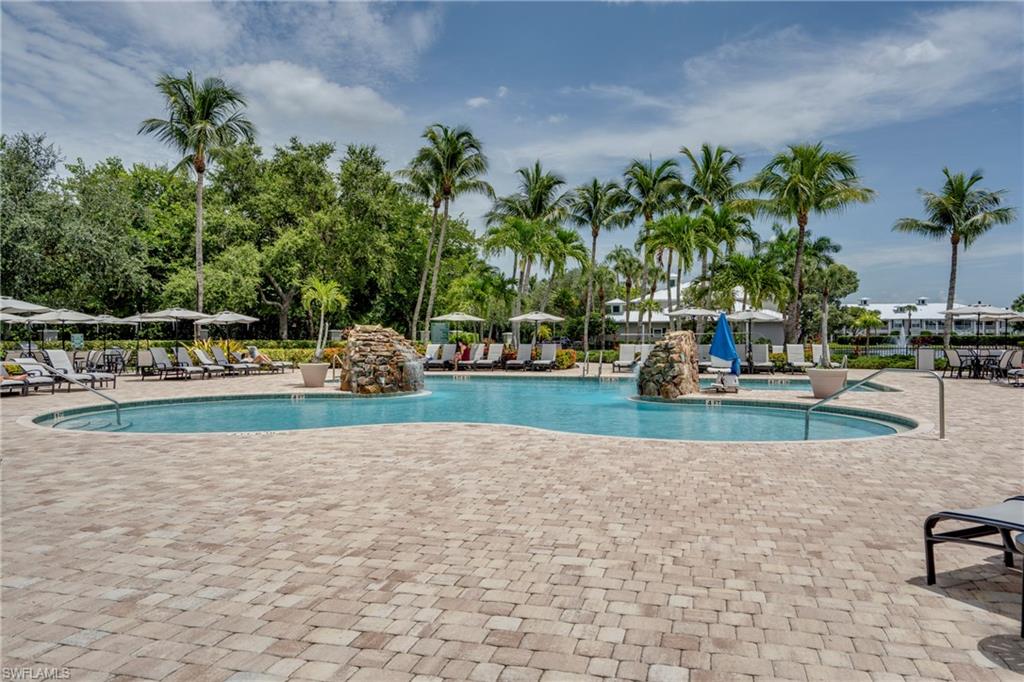 7930 Mahogany Run Lane, Unit 824 Naples, FL 34113 - Photo 32 of 40 a view of a swimming pool with a yard
