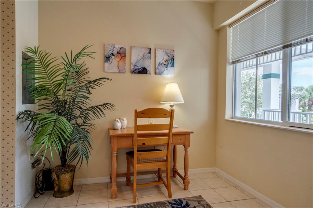 7930 Mahogany Run Lane, Unit 824 Naples, FL 34113 - Photo 6 of 40 a bedroom with a bed and a potted plant