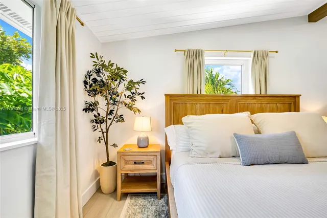 a balcony with furniture and a potted plant