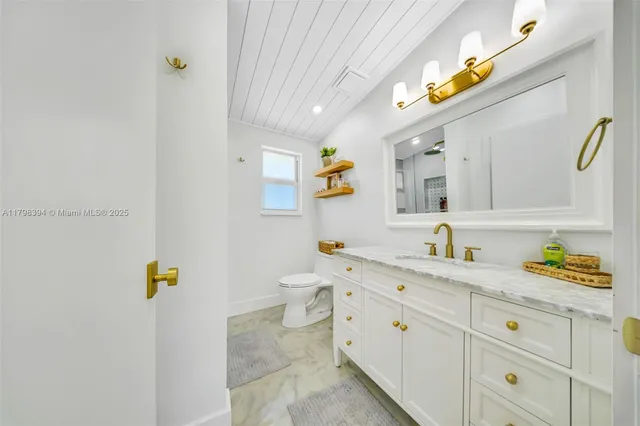 a view of a yard with plants and trees