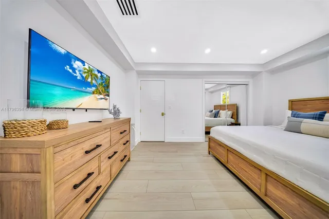 a bed room with two beds and a night stand