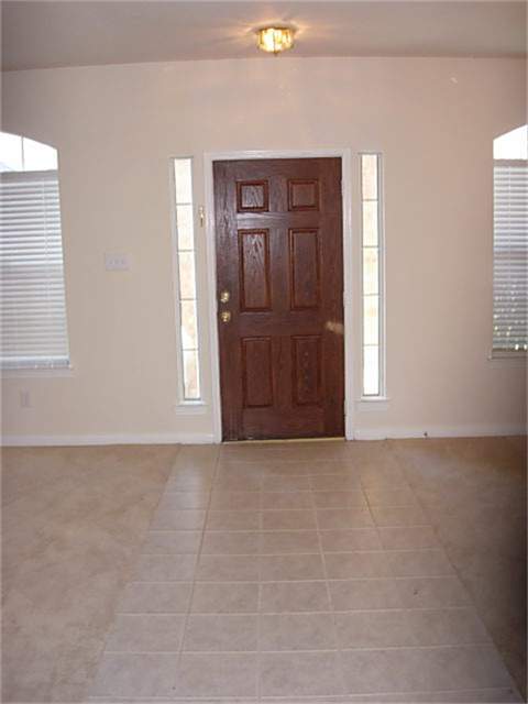 29614 North Legends Bend Lane Spring, TX 77386 - Photo 7 of 12 ENTRYWAY WITH CERAMIC TILE SEPERATES FORMAL DINING FROM FORMAL LIVING ROOM OR POSSIBLE HOME OFFICE?