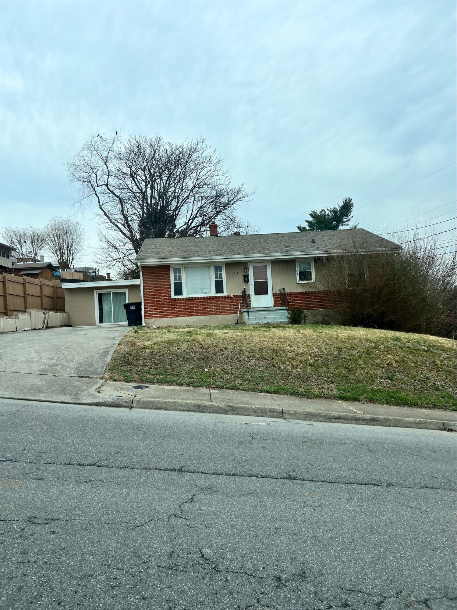 a front view of house with yard and trees around