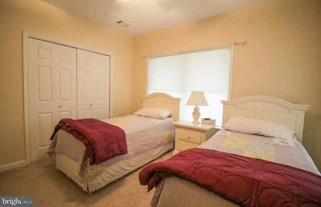 a bedroom with two beds and a night stand