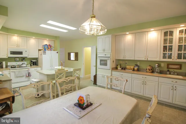 a large kitchen with a table and chairs