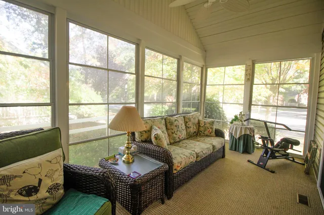 a living room with furniture and a floor to ceiling window