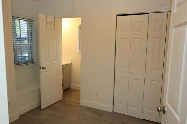 a view of an empty room with closet area