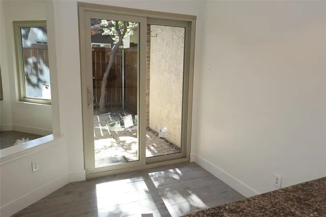a view of a hallway with windows and chandelier