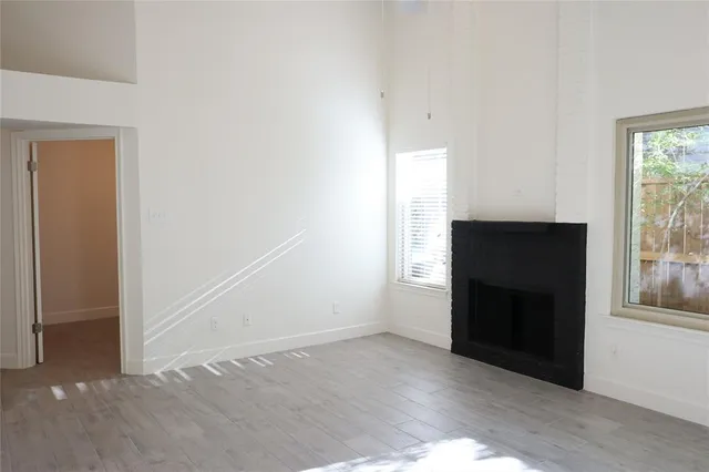 an empty room with windows and entrance