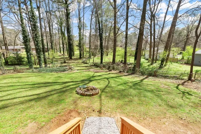 a view of a backyard with swimming pool