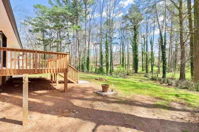 a view of swimming pool with lawn chairs and couches