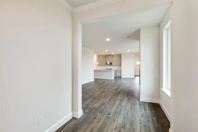 a view of a kitchen cabinets wooden floor and a kitchen