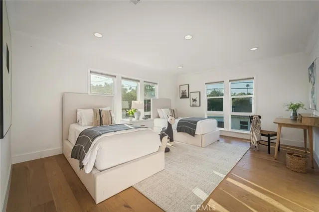 a bedroom with bed and a large window